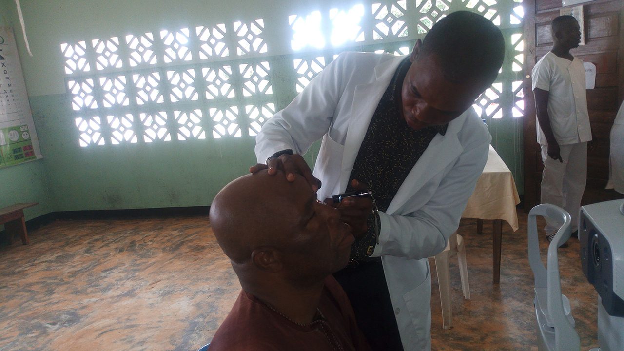 Homme ausculté par un ophtalmologue dans le cadre d'une journée de sensibilisation à la santé organisé par le DYPAMAK